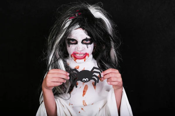 Concetto horror di Halloween. carino poco spaventoso ragazza in mostro zombie costume su sfondo nero . — Foto Stock