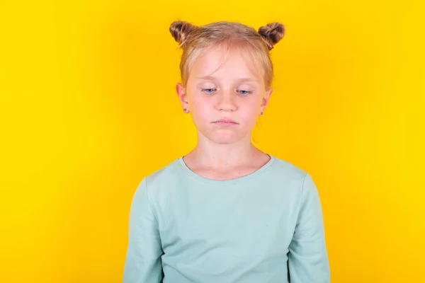 Emoção de crianças irritadas, tristes e perturbadas. bonito chateado menina de pé isolado sobre amarelo fundo — Fotografia de Stock