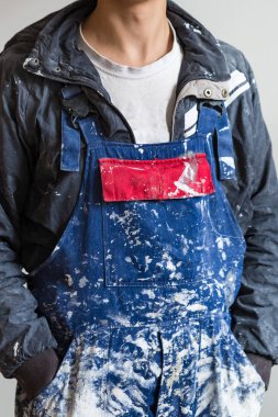 The dirty uniform or boilersuit - working dress of house-painter in house is under construction, remodeling, renovation, extension, overhaul, restoration and reconstruction  clipart