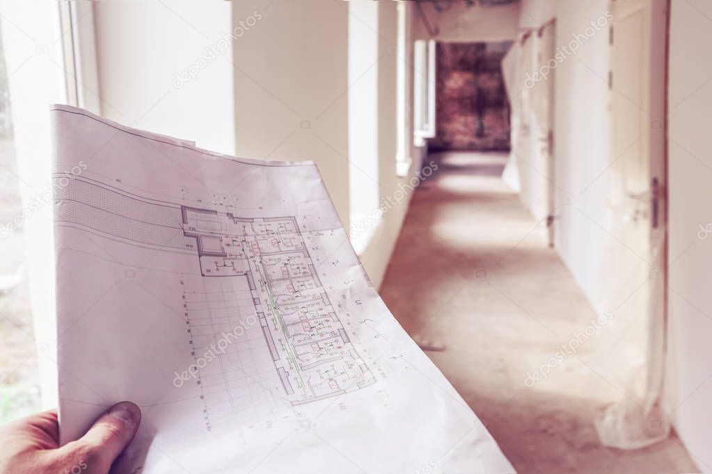 Architectural  plan with details, marked by measurements, construction and design details in engineer hand and corridor with windows, doors,  in an apartment during on the construction,overha