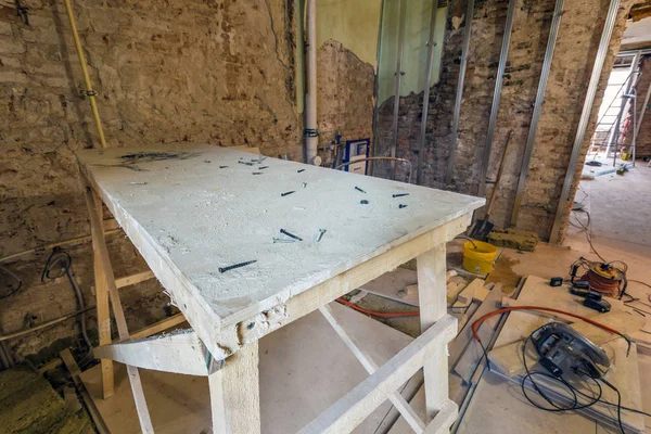 Holzbretter mit Schrauben im Zimmer und Bauwerkzeuge sind in einer Wohnung während auf dem Bau, Überholung, Umbau, Wiederaufbau, Heimwerker und Renovierung. — Stockfoto