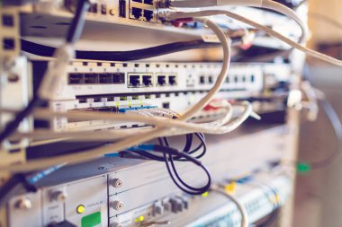 Ekipman radyo baz istasyonu yakın çekim, mavi ve sarı optik yama halatlar, elektrik rj-45 yama halatlar ve veri kabloları. Internet. İletişim. Ağ. Veri Merkezi