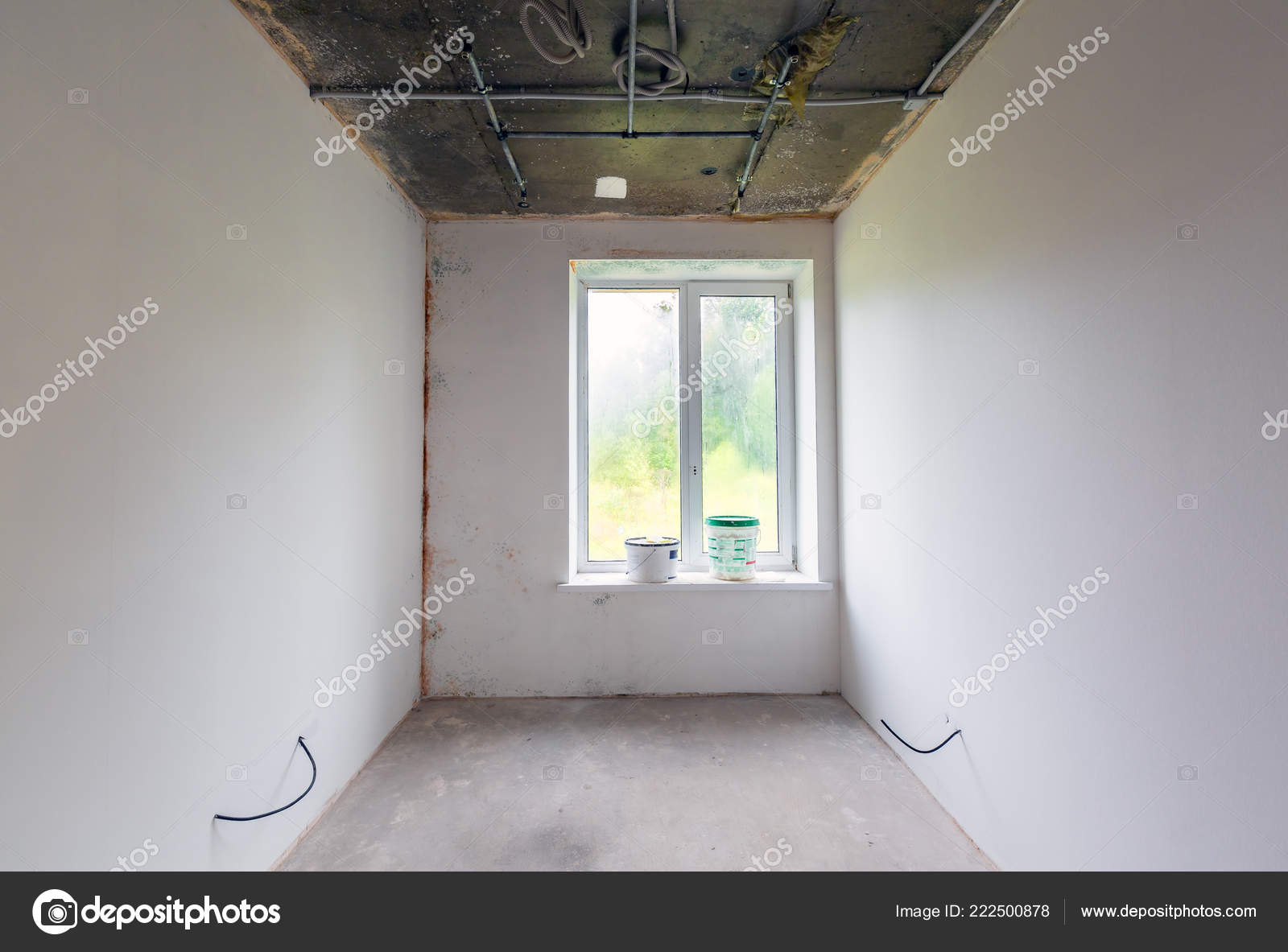 Small Room With White Walls And Electrical Wires Paint And Putty
