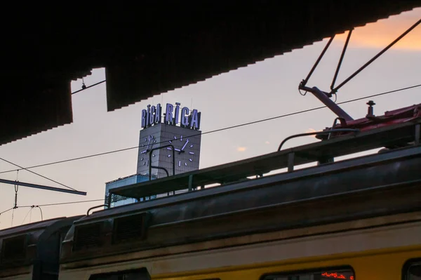 Riga, Letônia - 7 de maio de 2017: Vista sobre a torre com relógio e título RIGA da Estação Central de Trem em Riga, Letônia . — Fotografia de Stock