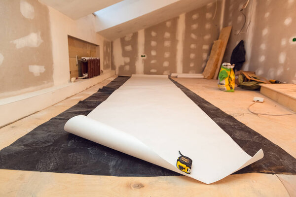 Working process of wallpapering on the drywall in small room apartment is under construction, remodeling, renovation, extension, restoration and reconstruction. Paperhangings is measured by tape
