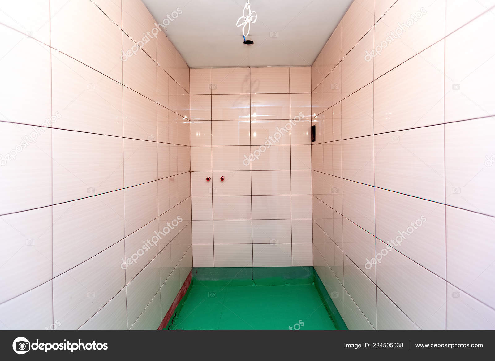 Bathroom With Tiled Walls And Floor Painted By Green Colored