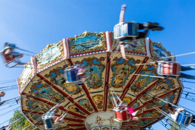 Rusya, Saint Petersburg - 31 Ağustos 2019: Divo Ostrov eğlence parkı. Neşeli çocuklar ve yetişkinler ile Carousel. Hareket efekti