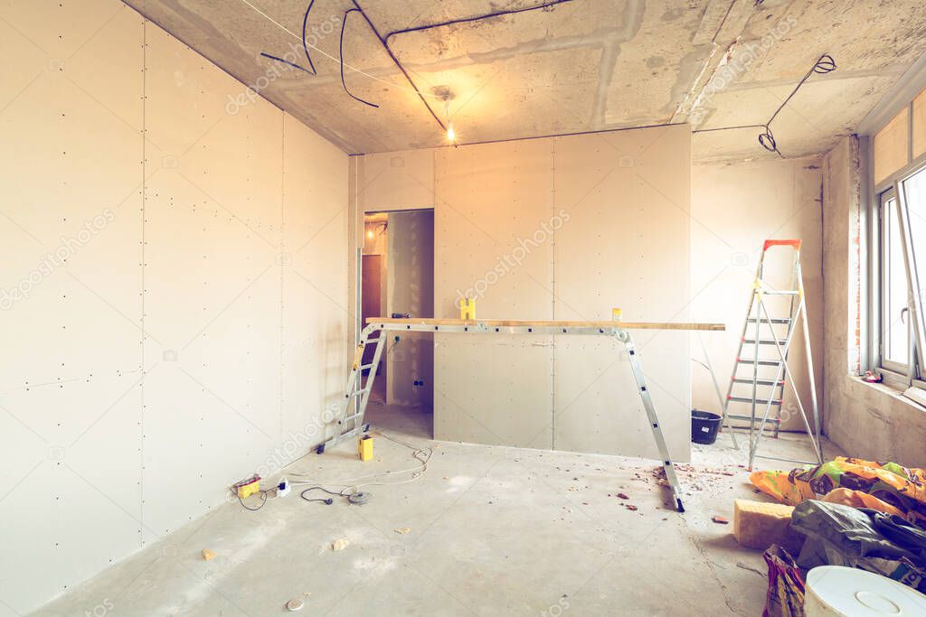 Working process of installing frames for plasterboard - drywall and construction tools in apartment is under construction, remodeling, renovation, extension, restoration and reconstruction.