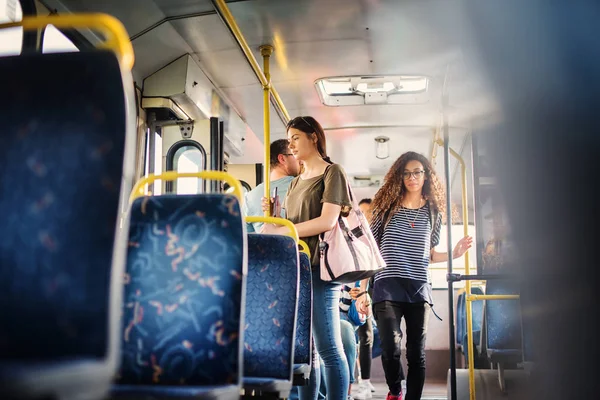 young attractive people travelling by bus