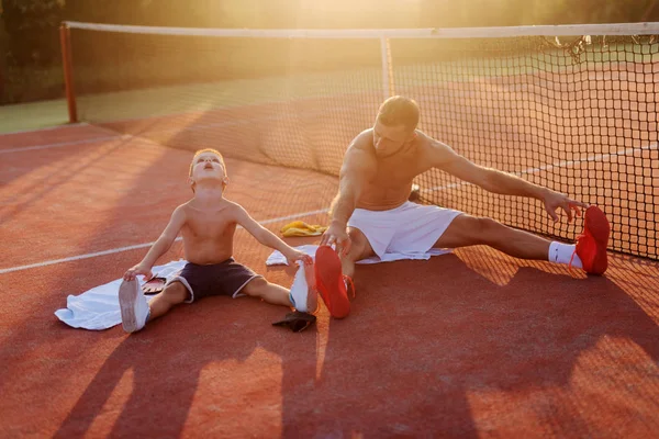 Father Son Training Together Sitting Training Field Stretching Hard Raining — Stock Photo, Image