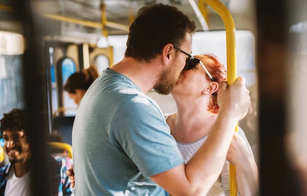 young adorable couple kissing in bus