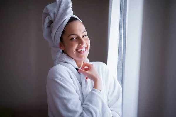 beautiful woman in robe smiling after shower