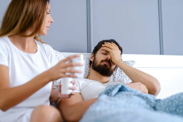 Worried Man Having Headache Lying Bed Home His Careful Girlfriend — Stock Photo, Image