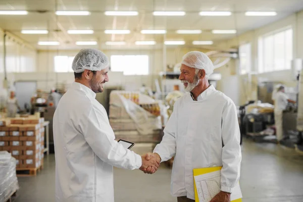 Зображення Двох Чоловіків Менеджерів Стерильному Одязі Трясуться Руками Харчовій Фабриці — стокове фото
