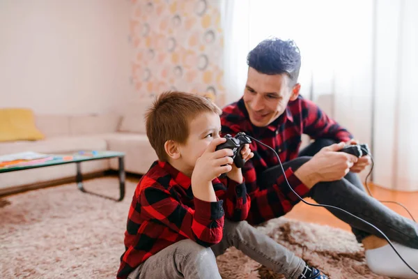 父と幼い息子のゲームパッドのコンソール ゲーム赤い シャツに 陽気な興奮 — ストック写真