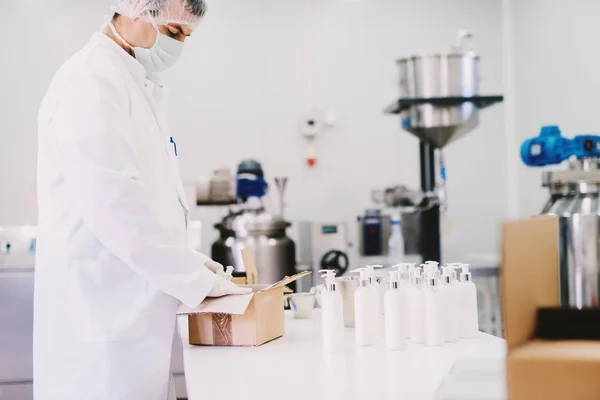 Wissenschaftler packt Kosmetikflaschen ein — Stockfoto