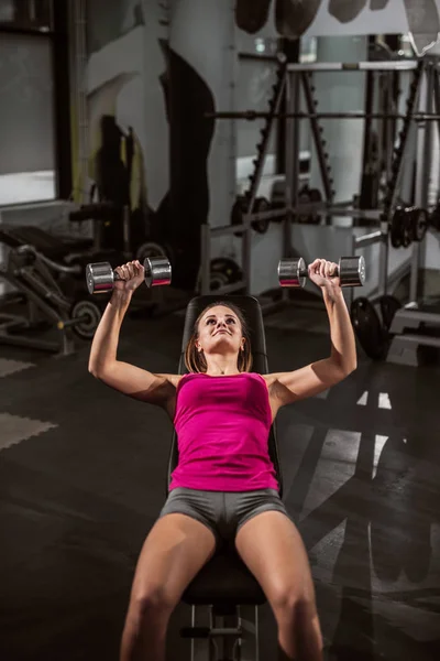 Frau Hebt Hanteln Während Sie Sich Auf Bank Hinlegt Fitnessstudio — Stockfoto