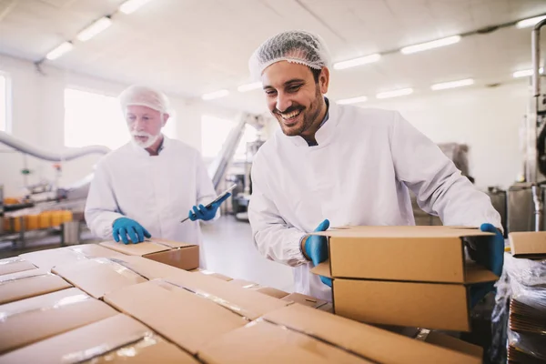 Two Male Colleagues Sterile Clothes Preparing Boxes Products Transport Standing — Stock Photo, Image