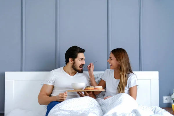 Happy Young Couple Having Breakfast Bed Beautiful Girl Feeding Her — Stock Photo, Image