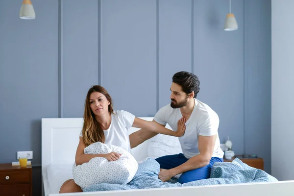 Young Bearded Man Looking His Unhappy Girlfriend While Sitting Bed — Stock Photo, Image