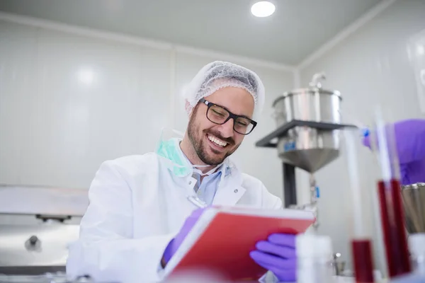 Smilling Man Writing Test Results While Sitting Lab — Stock Photo, Image