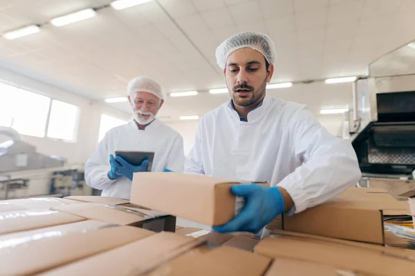 Hombre Apilando Cajas Mientras Que Otro Hombre Pie Fondo Uso —  Fotos de Stock