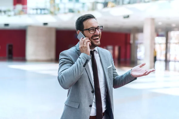 Lobide Duran Konuşmak Için Akıllı Telefon Kullanarak Mutlu Beyaz Işadamı — Stok fotoğraf