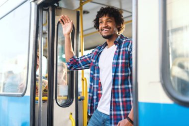 Young cheerful happy man in bus clipart