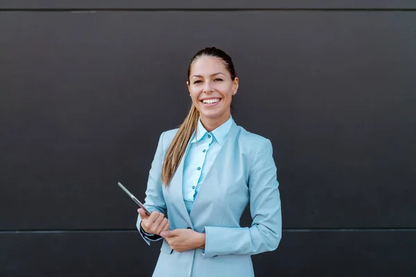 Sorrindo Bela Morena Terno Segurando Tablet Olhando Para Câmera Enquanto — Fotografia de Stock