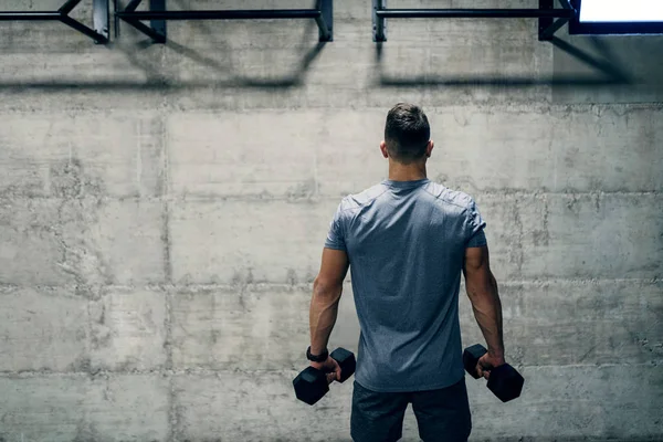 Man Holding Dumbbells While Standing Backs Turned You Only One — Stock Photo, Image