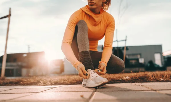 Zblízka Ženské Runner Klečí Vázání Tkaničky Ulici Slunečný Den — Stock fotografie