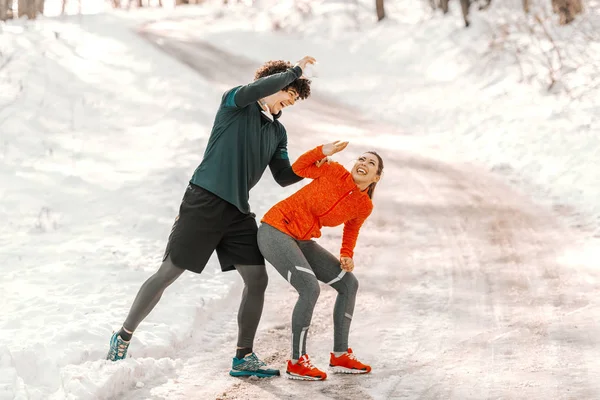 Smiling Sporty Caucasian Couple Playing Snowball While Standing Nature Trail — Stockfoto