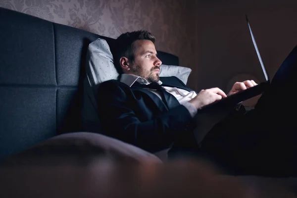 Бізнесмен Костюмі Лежить Ліжку Готельному Номері Використовує Ноутбук Роботи Концепція — стокове фото
