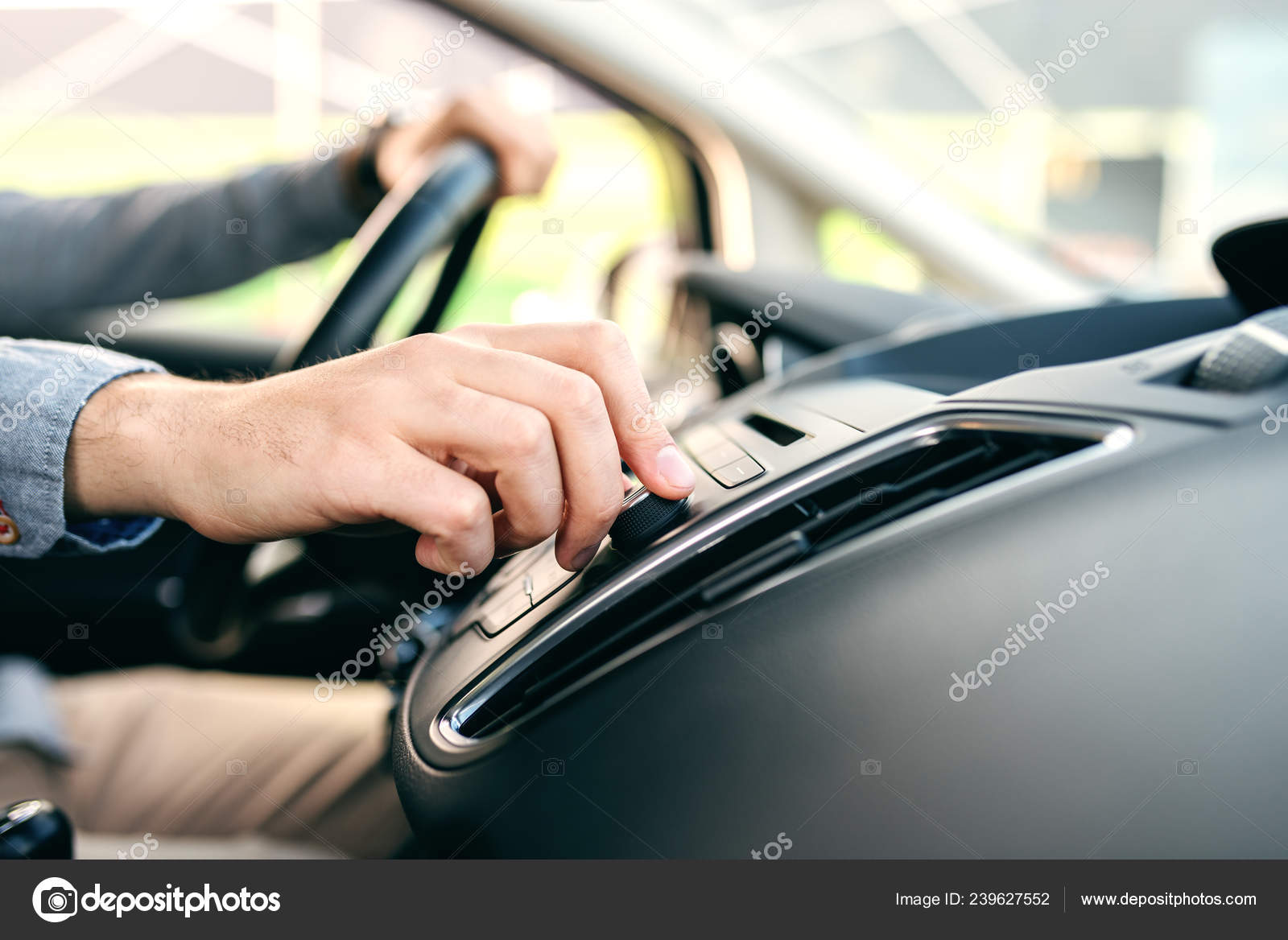 Close Man Changing Radio Station While Driving Car Stock Photo by