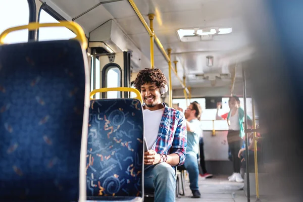 Smiling African American Guy Sitting Public Transportation Using Tablet Ears — Stock Photo, Image