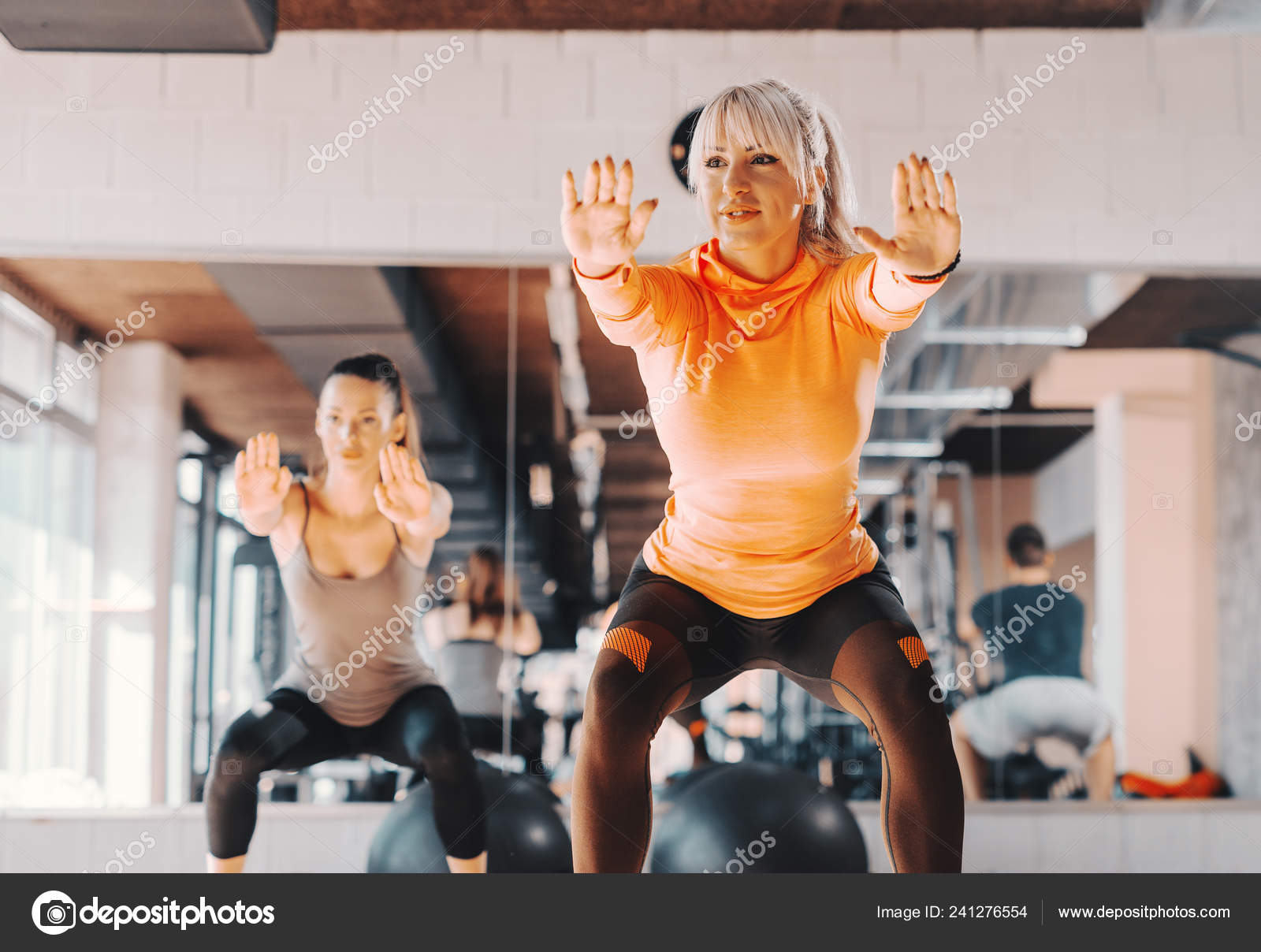 Happy Caucasian Sportswear Doing Endurance Squatting Position Gym Stock Photo by ©dusanpetkovic 241276554