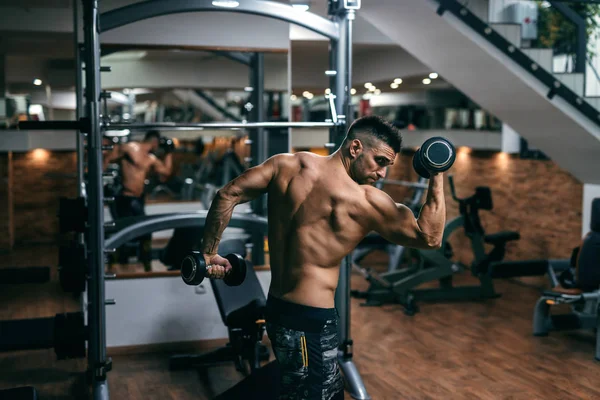 Starker Muskulöser Mann Der Mit Hanteln Einem Fitnessstudio Posiert Seitenansicht — Stockfoto