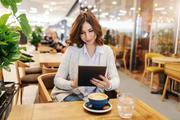 Gorgeous Smiling Brunette Dressed Casual Using Tablet Sitting Cafeteria Desk — Stock Photo, Image