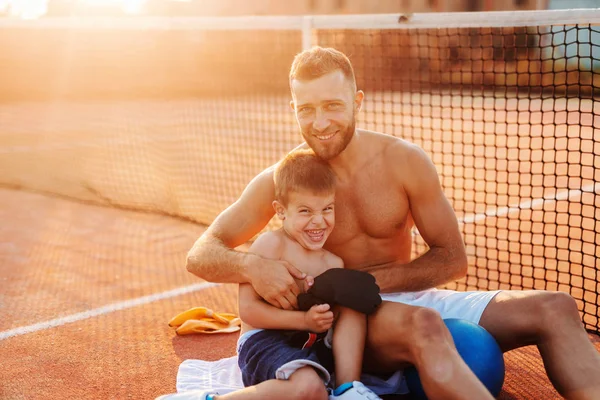 Smiling Shirtless Father Hugging His Son While Sitting Court Morning — Stock Photo, Image