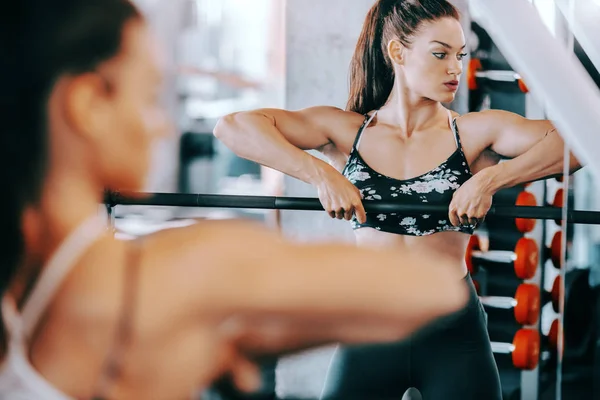 Portrait of beautiful Caucasian female bodybuilder posing with