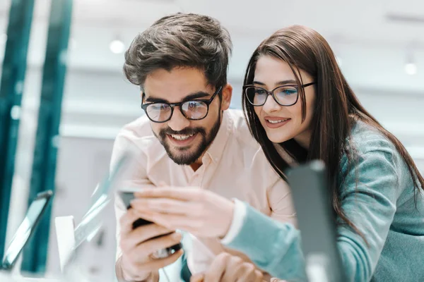 Young Smiling Multicultural Couple Eyeglasses Trying Out New Smart Phone — Stock Photo, Image