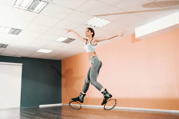 Attractive Caucasian Brunette Sportswear Kangoo Jumps Footwear Jumping Gym Girl — Stock Photo, Image
