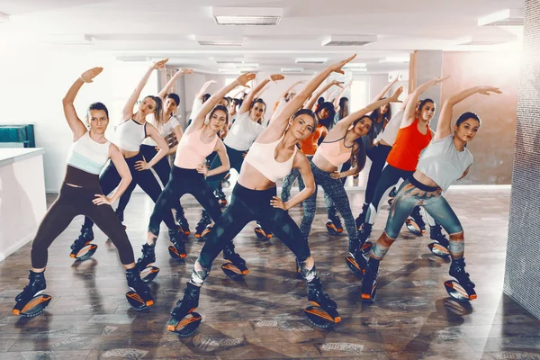 Woman exercising with kangoo jumps shoes and stepper Stock Photo