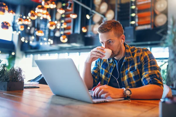 Young Caucasian Blogger Earphones Ears Plaid Shirt Drinking Coffee Using — Stock Photo, Image