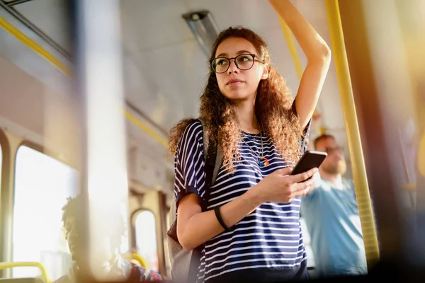 Young Serious Cute Girl Standing Bus Holding Bar While Listening — Stock Photo, Image