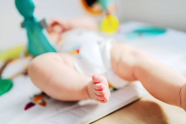 Healthy Caucasian Baby Playing Crib Toys Close Baby Feet Selective — ストック写真