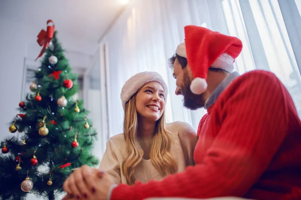 Charming Caucasian Couple Sweaters Santa Hat Heads Sitting Sofa Living — Stock fotografie