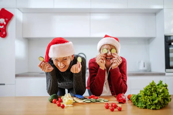 Playful Caucasian Woman Holding Cucumber Slices Front Her Eyes While — ストック写真