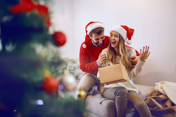 Excited Caucasian Smiling Woman Holding Gift Sitting Sofa Living Room — Stock Photo, Image