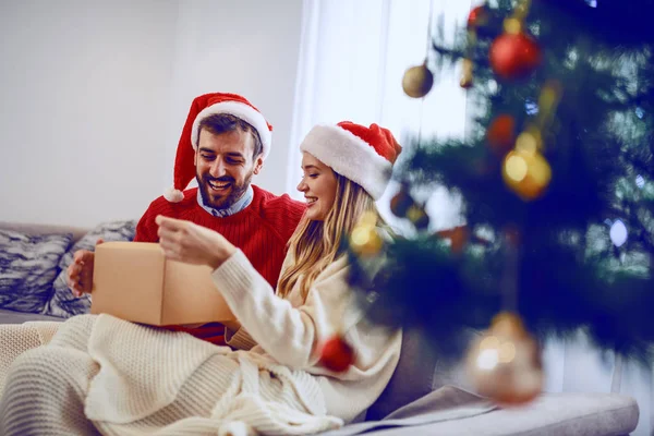 Adorable Smiling Caucasian Couple Santa Hats Heads Siting Sofa Living — Stock Photo, Image